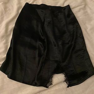 Silky black skirt with lace slit